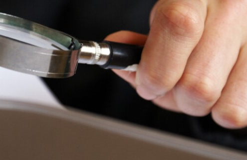 cropped hand holding magnifying glass_canstockphoto46970201 770x320